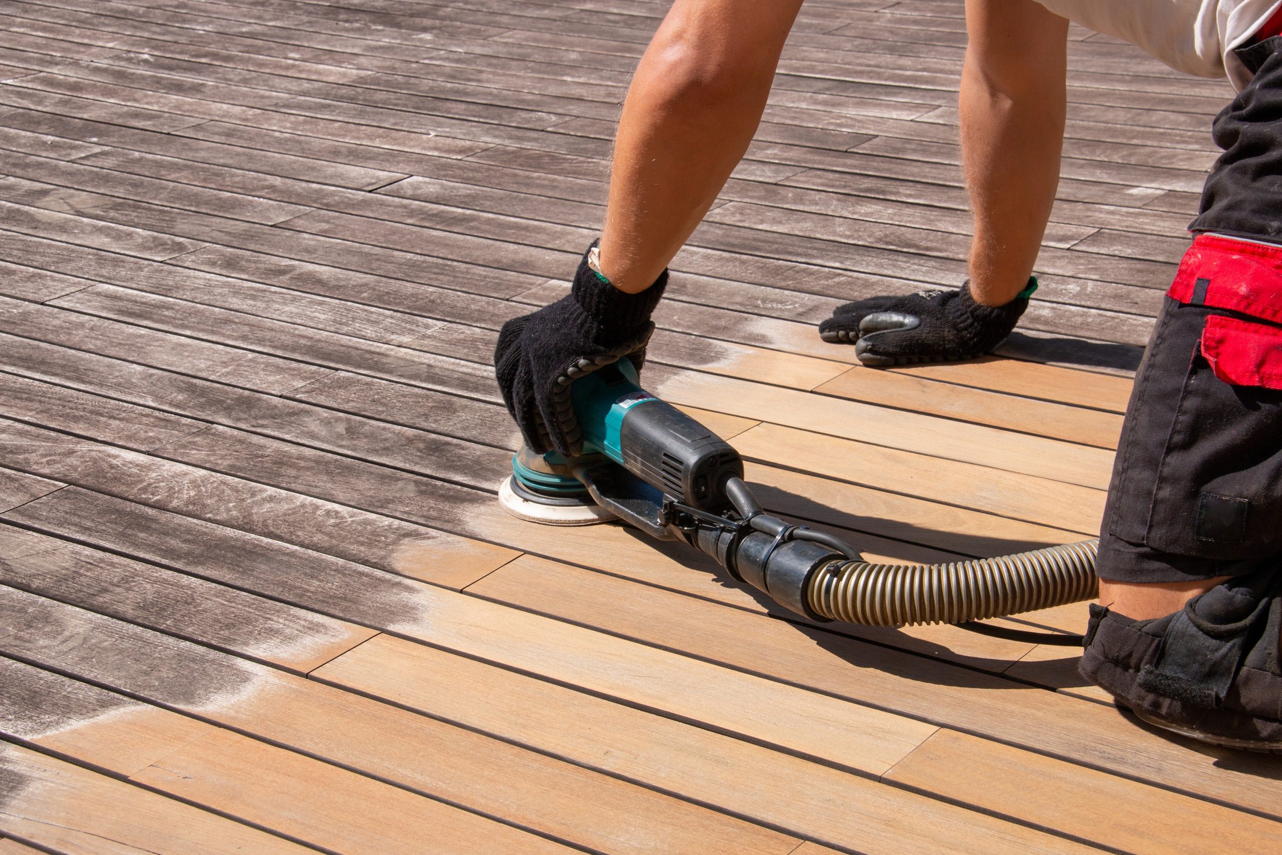 Deck Sanding in City – professional sanding of weathered hardwood timber decking boards to restore a smooth, clean outdoor floor surface.