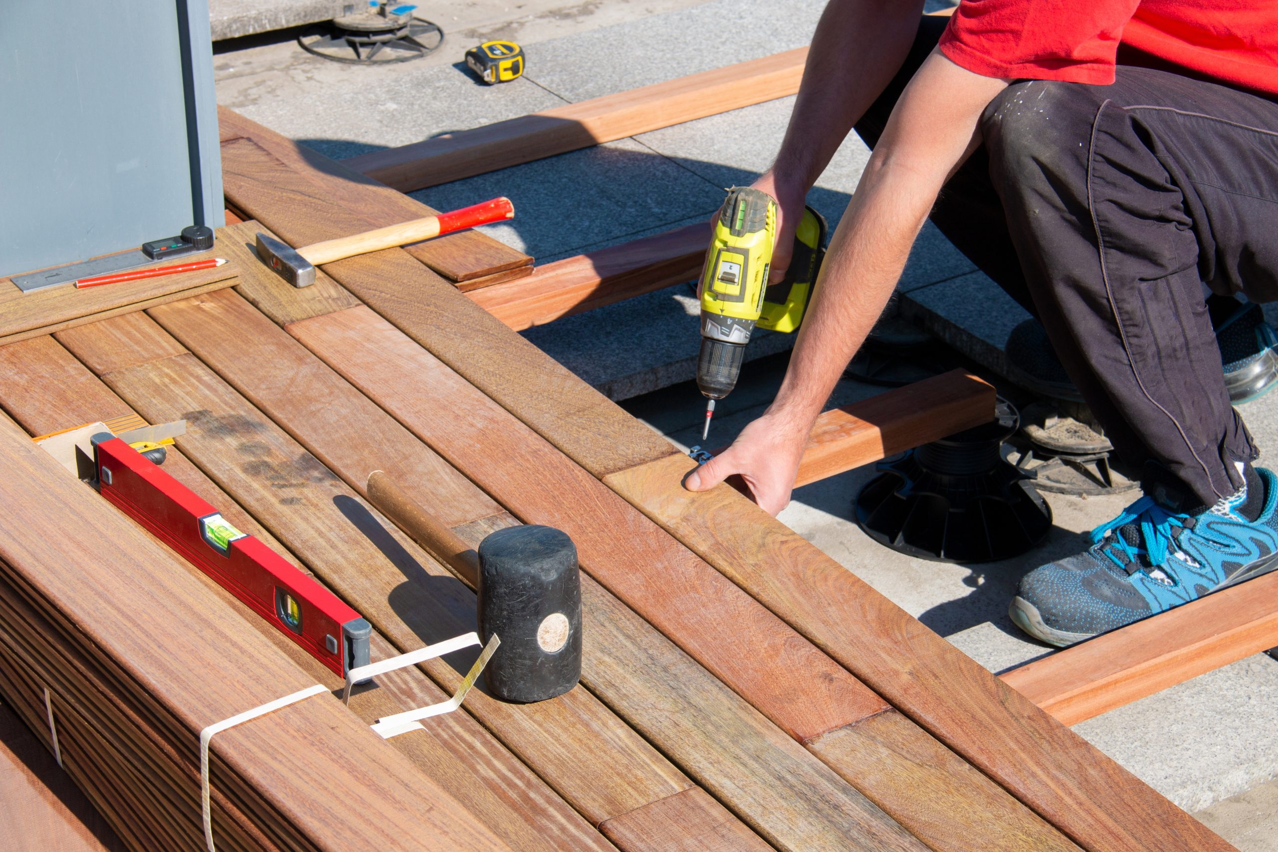 Deck Sanding in City – repairs being carried out on a hardwood timber garden deck floor before sanding and refinishing.