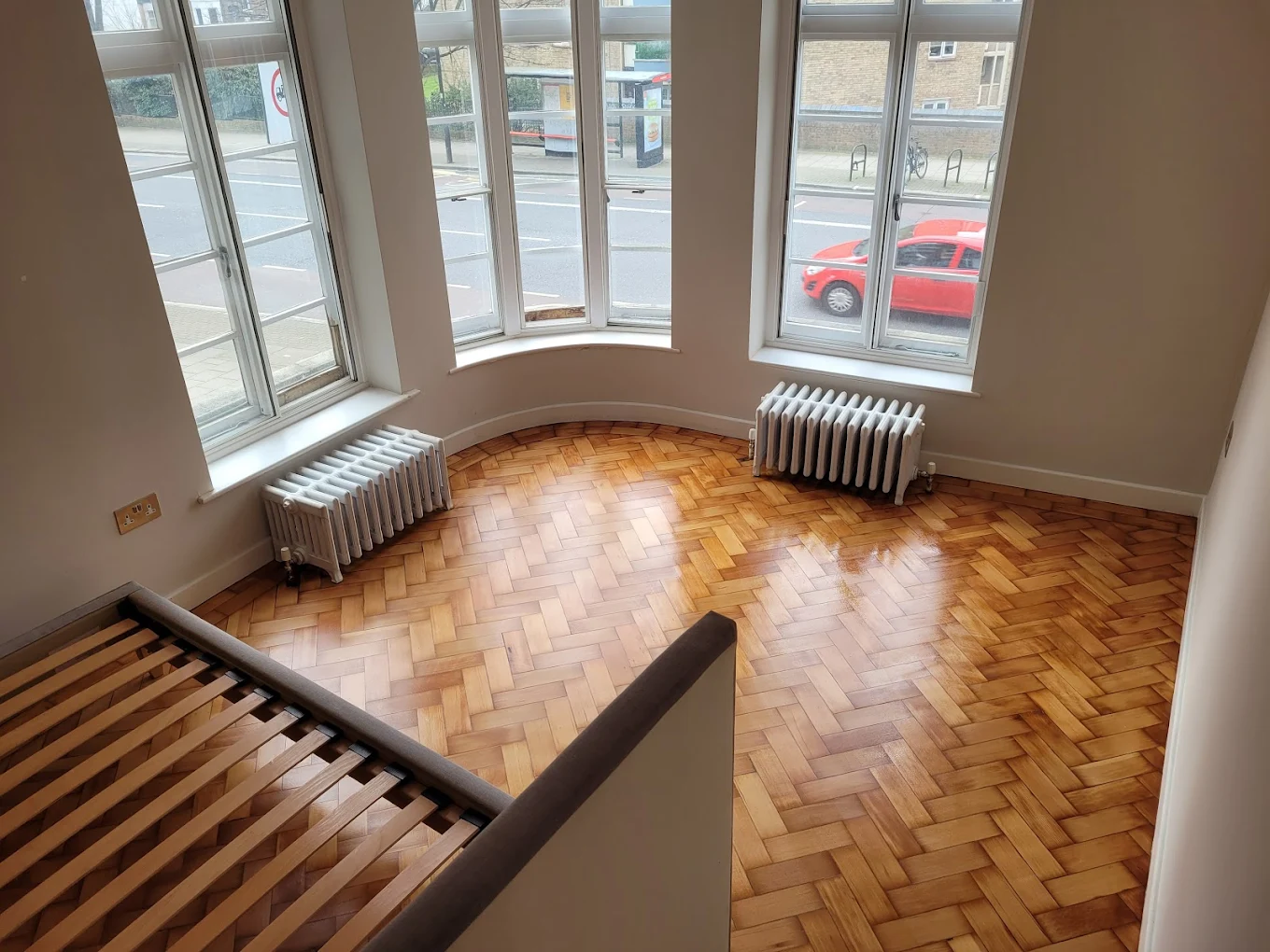 Parquet Floor Restoration completed on an oak herringbone parquet floor, showing a beautifully sanded and refinished wood surface with a warm natural sheen.